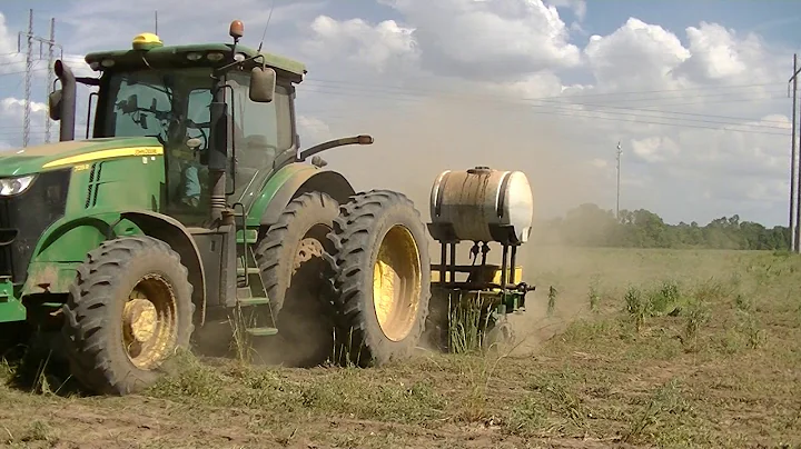 7215R WITH SIX-ROW JOHN DEERE PLANTER PLANTING COT...