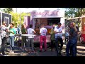 Two women makes a lot grilled sandwiches in a small trailer  american street food in berlin