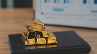 Gold bar stock footage Holding gold bars against grey textured background, closeup Free Video