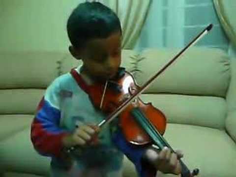 Joseph practicing his violin lesson at home