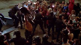 The Running Man - Buzzsaw lifts his motorcycle