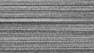 A flickering, analog TV signal with bad interference noise background