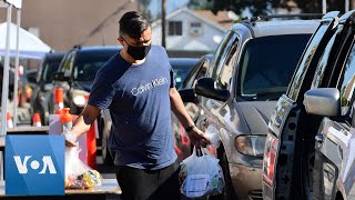 Hundreds of cars line up at a high school parking lot to pick food
from bank, los angeles, california, tuesday, april 14. pulled two
severa...