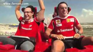 Ferrari driver fernando alonso of spain, right, and his teammate
felipe massa brazil wave as they run on a rollercoaster car modelled
th...