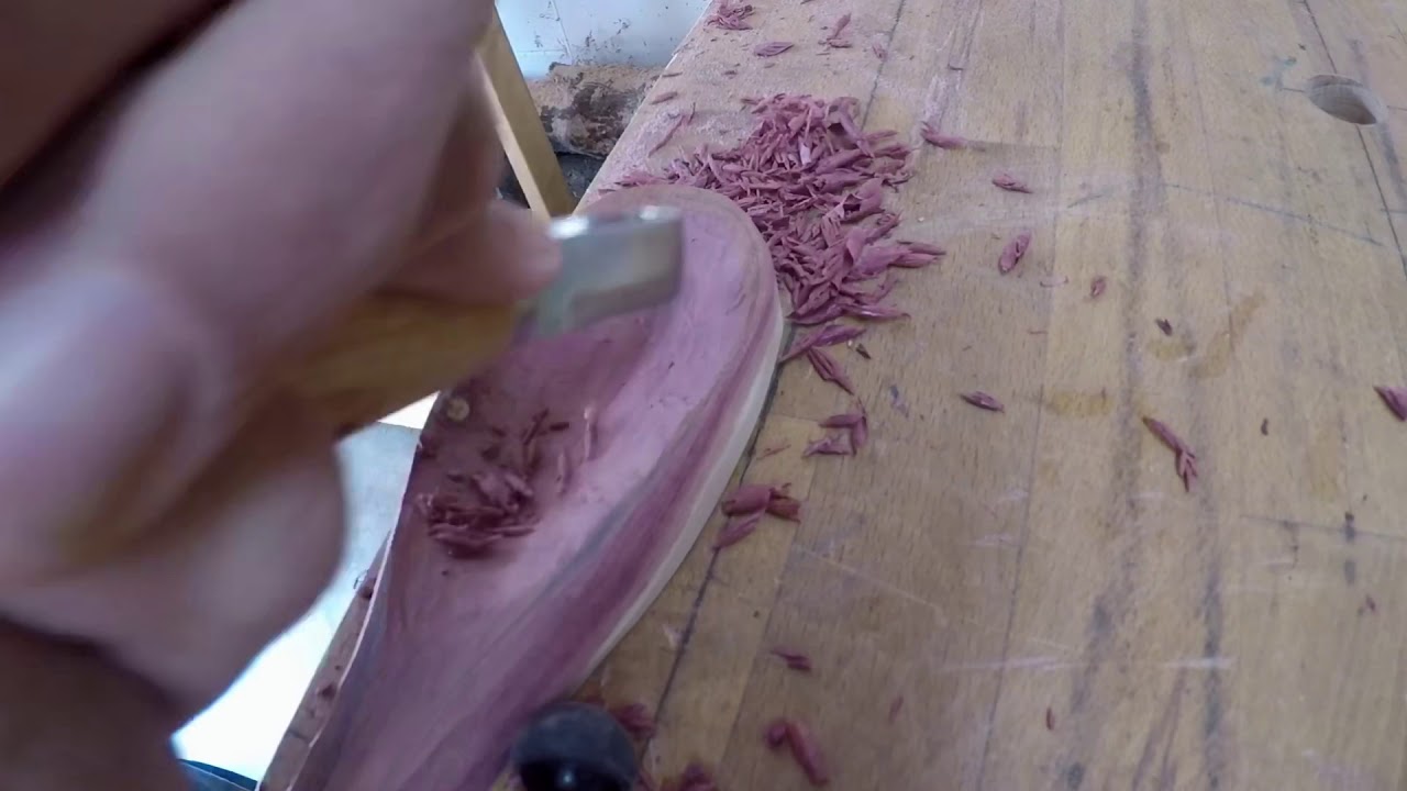 Carving a wooden cedar spoon