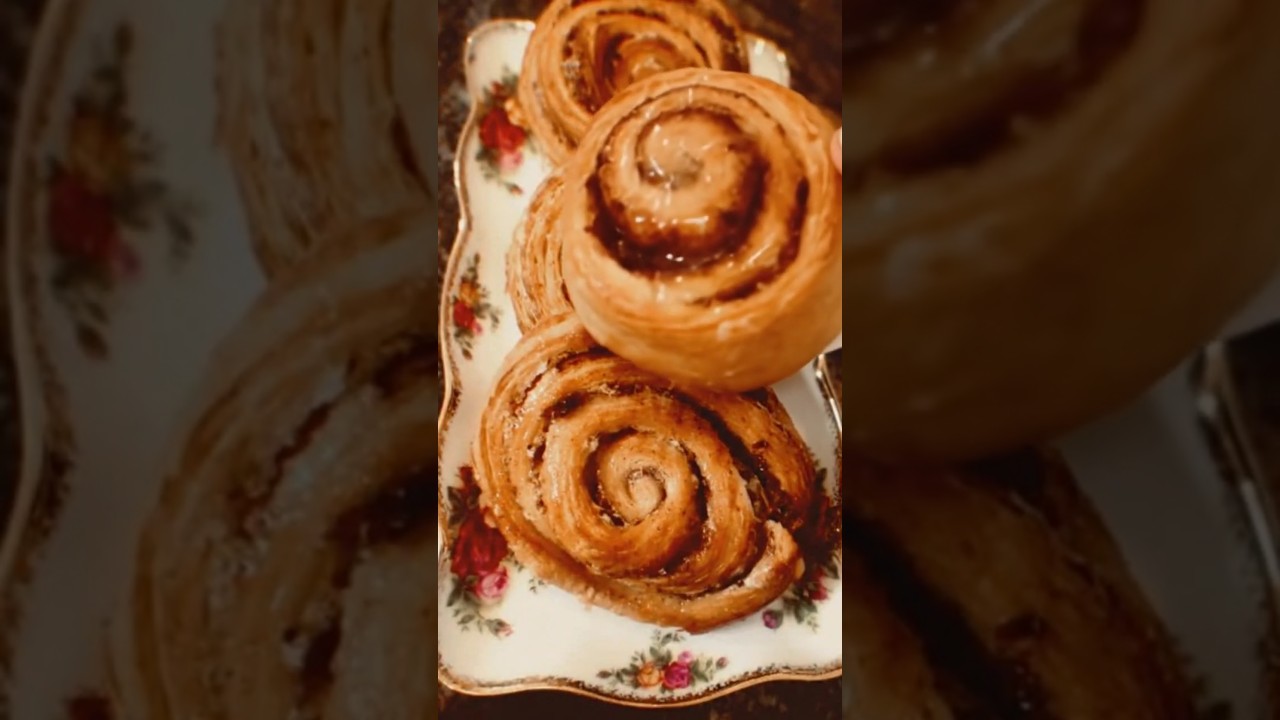 icing sugar dripping over cinnamon swirls 
