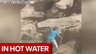 Woman wades into Trevi Fountain to fill water bottle