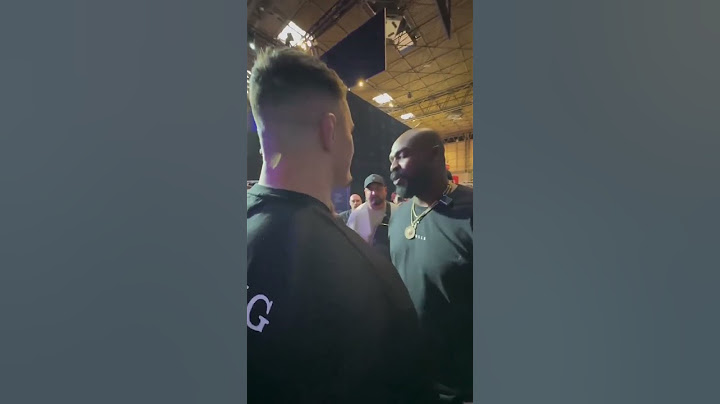 UFC Heavyweight Champion Jon Jones shrugs off Tom Aspinall's hand from his shoulder