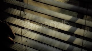 Looking Through Window Blinds. Stock Footage