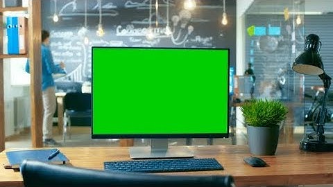 Personal Computer with Mock-up Green Screen Monitor Stands on the Office Desk. | Stock Footage -