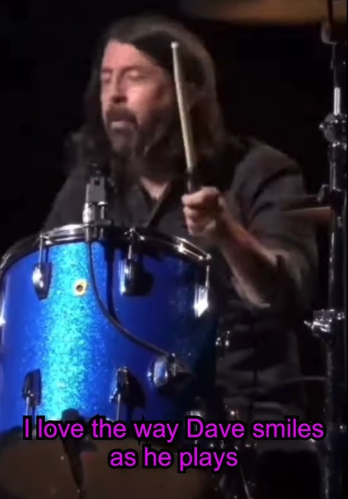 Dave Grohl smiles as he plays Nirvana.