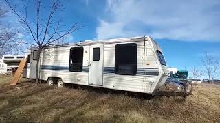 Junkyard Parts Picking Looking for Camper Parts in a Large Auto Wrecking Yard