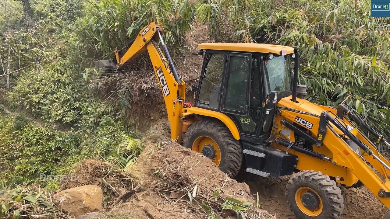 Mountain Top Narrow Road Building Cutting Steep Hillside with JCB