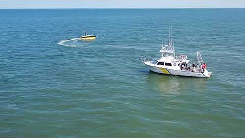 University of Delaware staff and students using new robot boat
