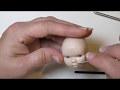 Sculpting a baby doll head.