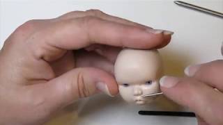 Sculpting a baby doll head.