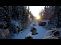 The low winter sun is shining over a river in a snowy forest - a relaxing nature video