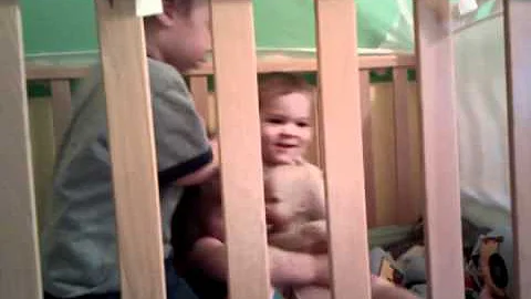 Calix, Robert, and Elizabeth in a crib