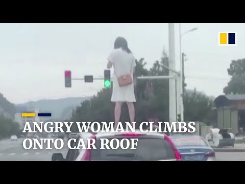 Chinese woman climbs onto car roof after argument with husband