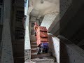 Brick Transport Cart Carrying Loads Down Stairs