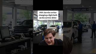 POV: Service writer changing a light bulb on the service drive