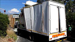 Power Truck Hire worker reverses the truck from underneath the Elgin Road bridge