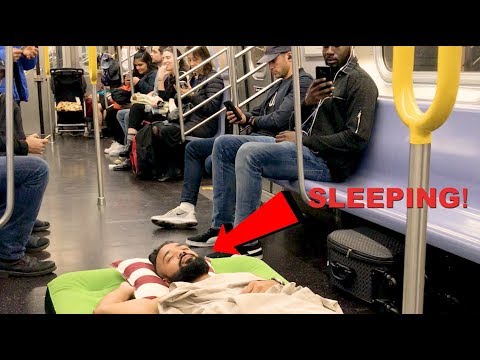 Man Takes A Nap On Air Bed (NYC Subway)