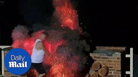 Terrifying moment man is engulfed in flames as he adds fuel to BBQ - Daily Mail