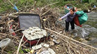 The girl was surprised find a large suitcase full of dollar bills been thrown away in garbage dump