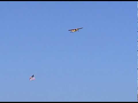 remote control plane pulling usa flag for national anthem before