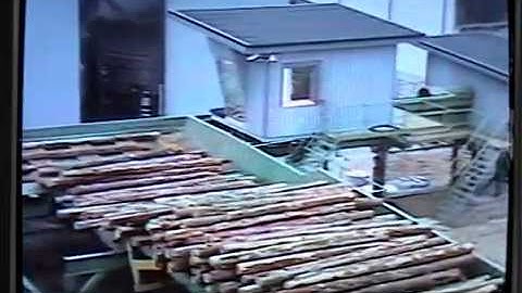 Log turning and feeding of long log to a debarker and sawmachine