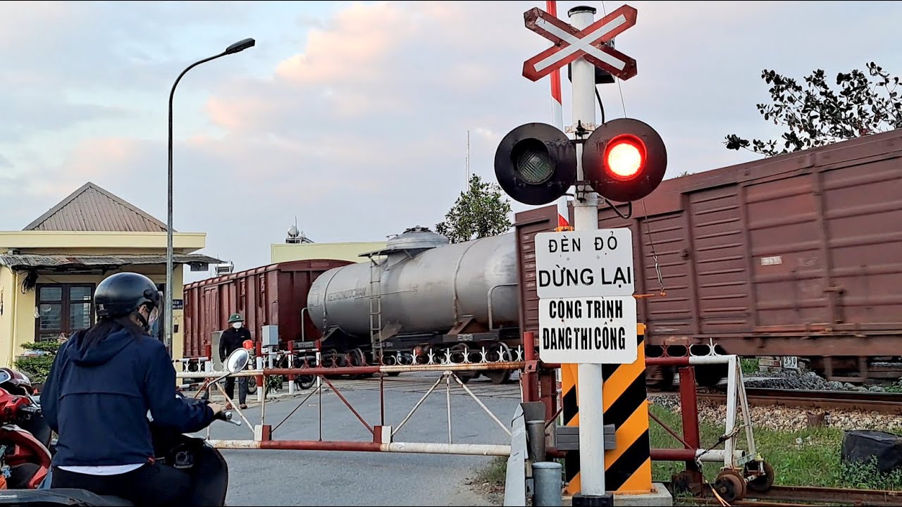 Train Crossing Village Road With The Red Signal Light On - Trains In Vietnam 2026