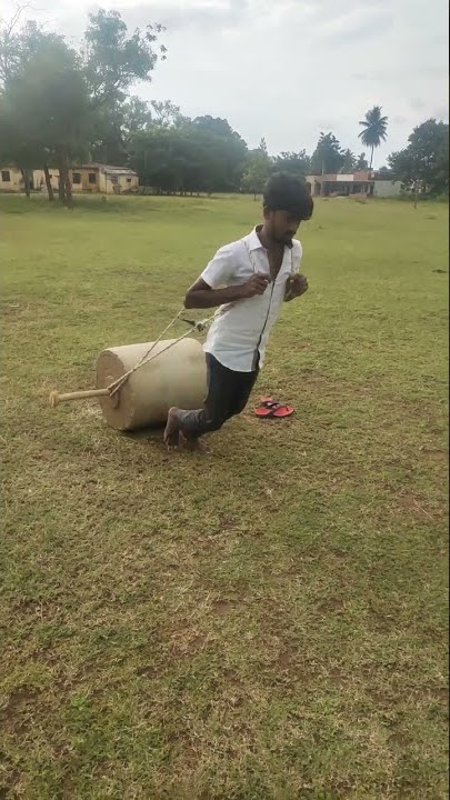 #Gundu Young boy pulling big round stone used for ragi, paddy fodder pressing(Gundu)