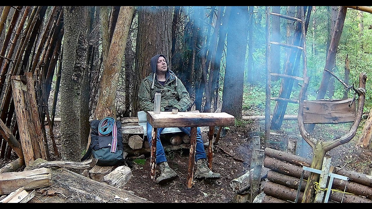 Bushcraft camp. Autumn shelter. Pillars in a frame for a winter shelter. Baked meat . No talking