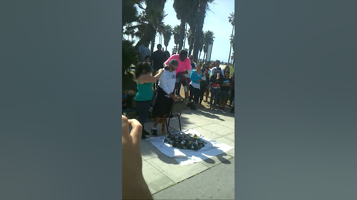 Guy walks barefoot on a pile of glass for money