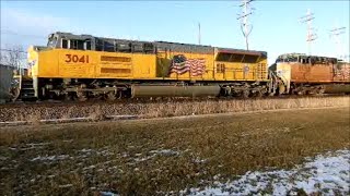 UP 3041 and UP 6066 lead a autorack train with a horn salute west through Geneva IL