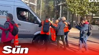 Protesters block fire engine and ambulance before van driver nudges them