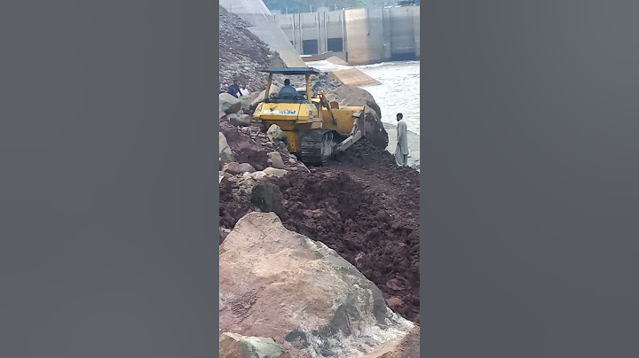 Dozer striving jobs to fall heavy stone in dam/run-off-river