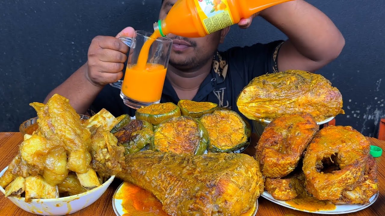 EATING MUTTON CHAP ,BIG FISH TAIL ,FISH HEAD ,FISH CURRY ,BRINJAL FRY WITH MANGO JUICE AND RICE 