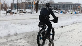 IMPD officer patrols streets on bicycle during winter snow storm