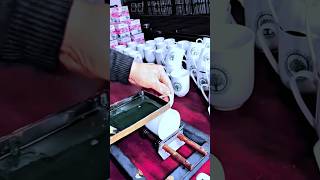 Tool for screen printing work on custom ceramic mugs with manual press
