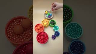 Relaxing Colorful Marble Dropping Into Beads Cups