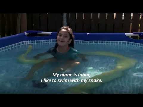 This 8-year-old girl loves to swim  with her 11-foot-long pet python - Watch this amazing video