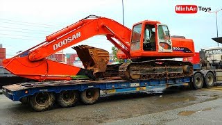 Excavator Truck: Excavator climbing on Truck, Fuso Self Loader Truck Unloading Excavator