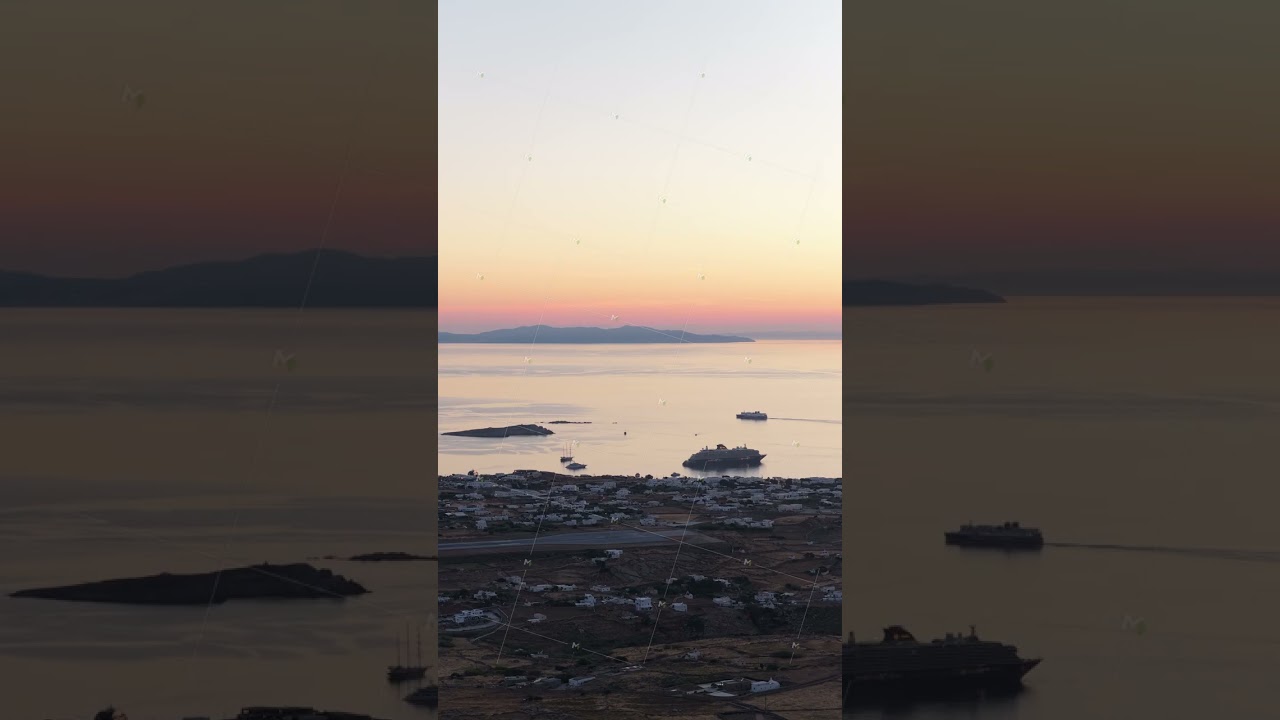 Romantic cruise ship vacation on Aegean Sea near Mykonos island, Greece, during summer sunset with