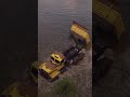 Sand dumping into river #roadcraft #heavymachinery #dumptruck #shorts #youtubeshorts