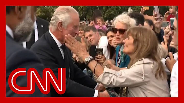 See moment woman kisses King Charles outside palace