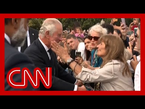 See moment woman kisses King Charles outside palace