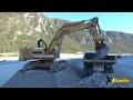 Liebherr 974 excavator digging and loading gravel on dumper perlini
