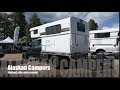 Pop up hard side camper on a flatbed with side entry by Alaskan Campers